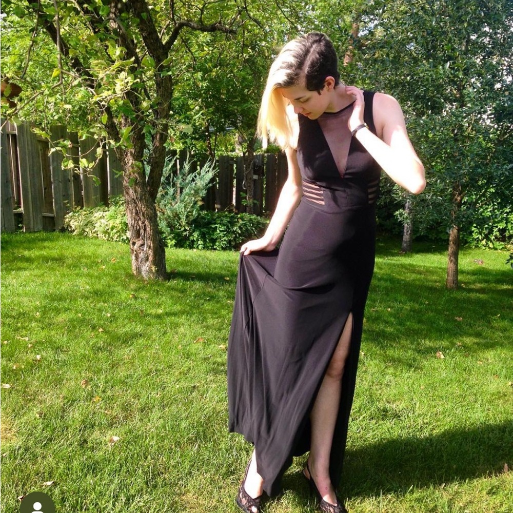 Black gown with mesh panelling and slit on left side.